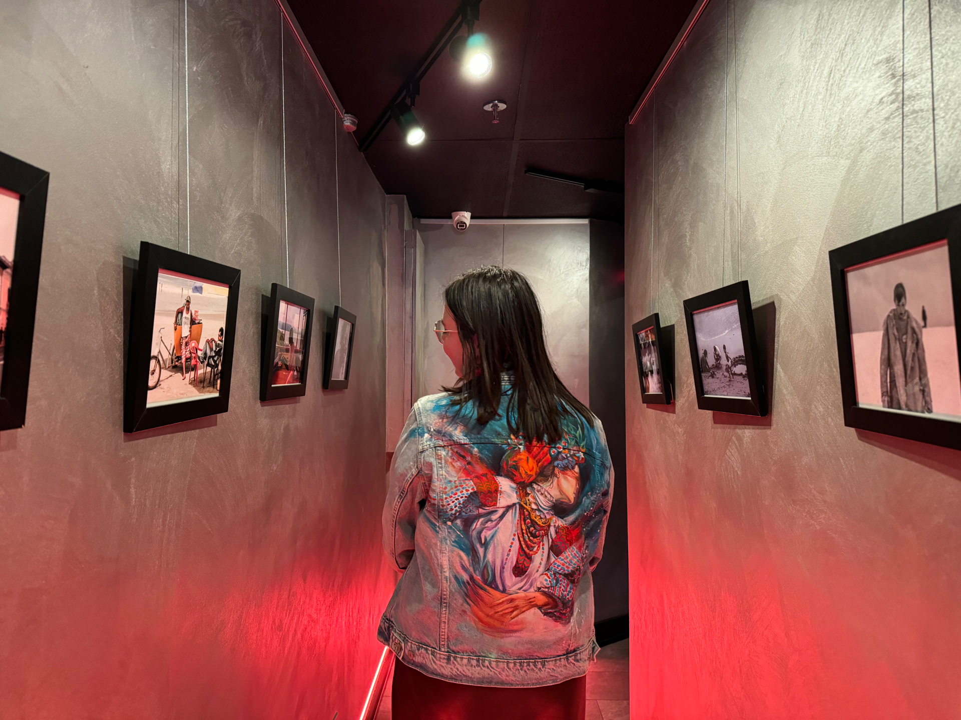 Visitor viewing framed photographs in the Visa-Free Entry solo exhibition